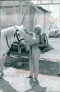 Sylvie Vartan pampering a horse.